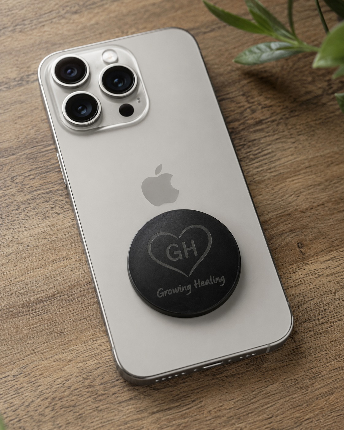 XL Shungite phone tab with Growing Healing logo attached to back of iPhone
