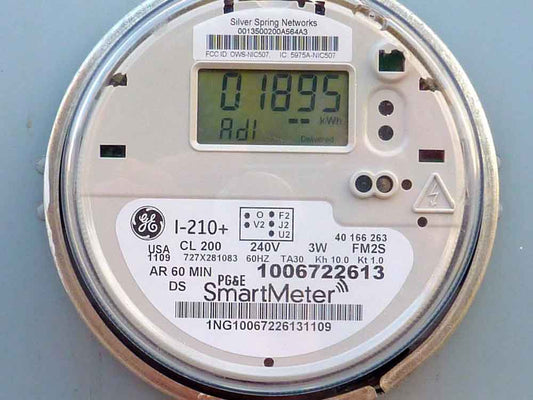 Digital smart meter displaying electricity usage installed on a residential home