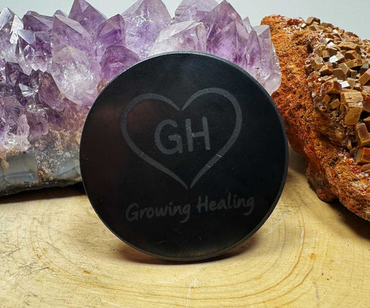 XL Shungite phone tab with Growing Healing logo on wooden surface with crystals