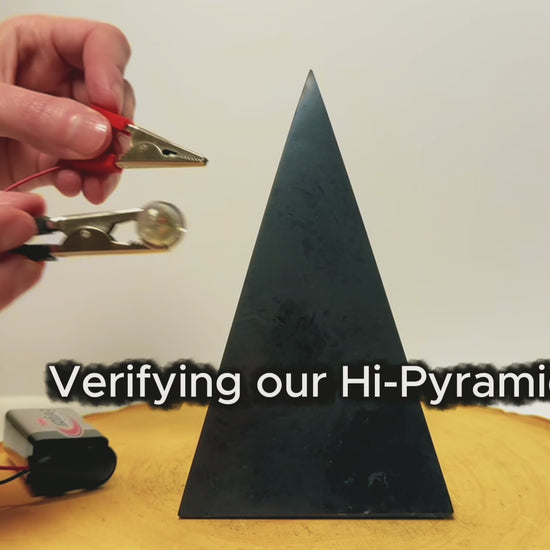 Testing the electrical conductivity of a tall, high-polished shungite pyramid.