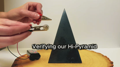 Testing the electrical conductivity of a tall, high-polished shungite pyramid.