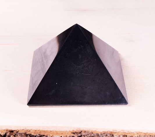 Authentic Karelian shungite pyramid close-up showcasing natural mineral veining and unique surface characteristics.
